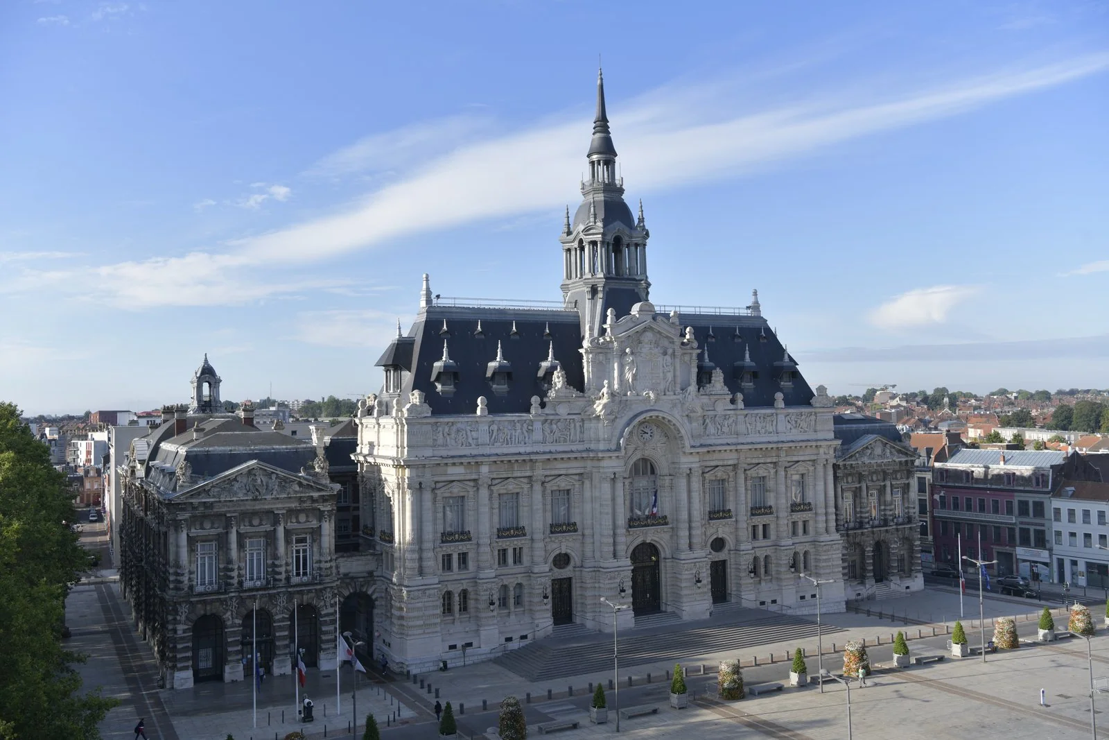 Façade et beffroi de l’hôtel de ville de Roubaix, avec la Grand-Place au premier plan.