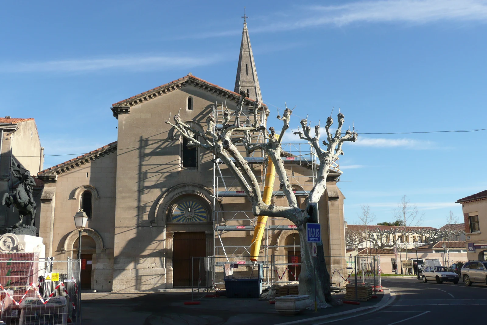 Église de Rognonas et sa place, avec des échafaudages sur une partie de la façade.